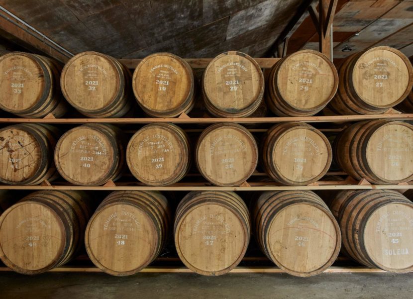 Whiskey barrels in a storage warehouse.