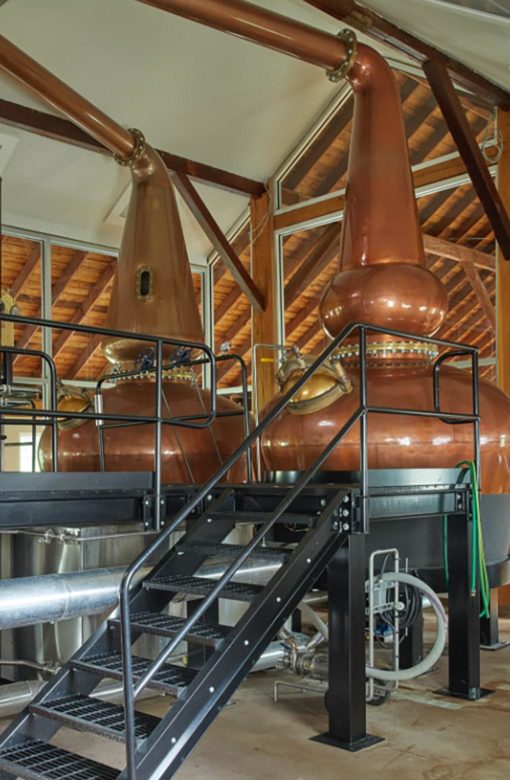 Small flight of stairs leading up to two large stills.
