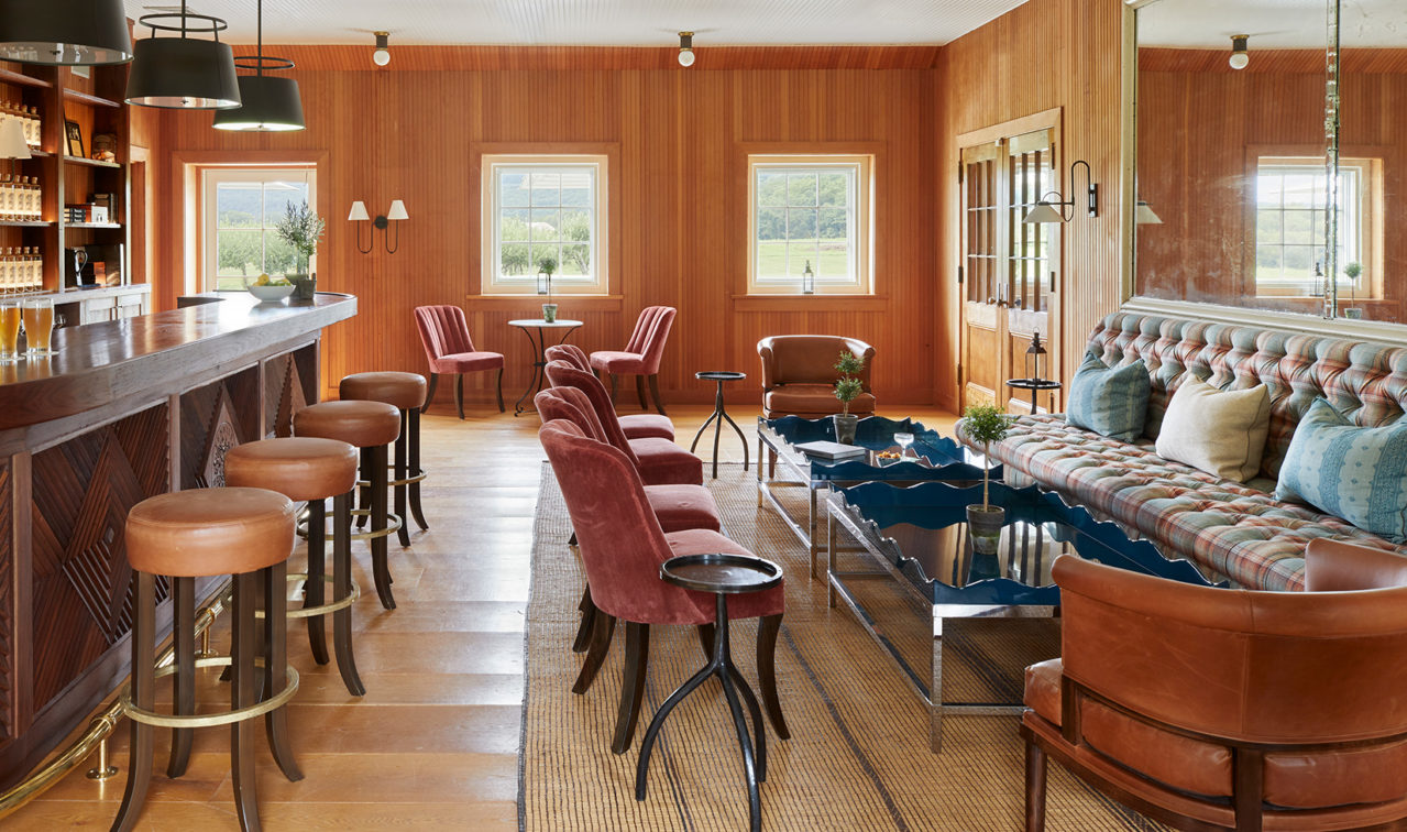 Wood paneled room with long bar and large seating area.