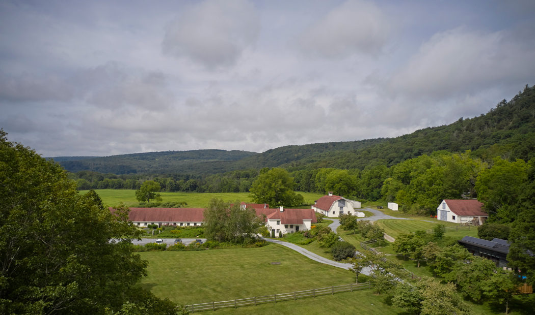 Tenmile Distillery Aerial photo of a large property with a white brick building.