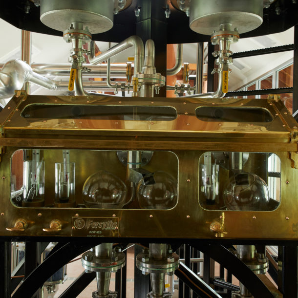 Brass spirit safe with various glasses inside.