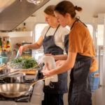 two women cooking in an airstream