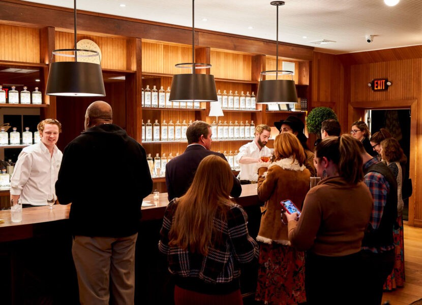 Tenmile Distillery Bar People gathered at a bar socializing and ordering drinks