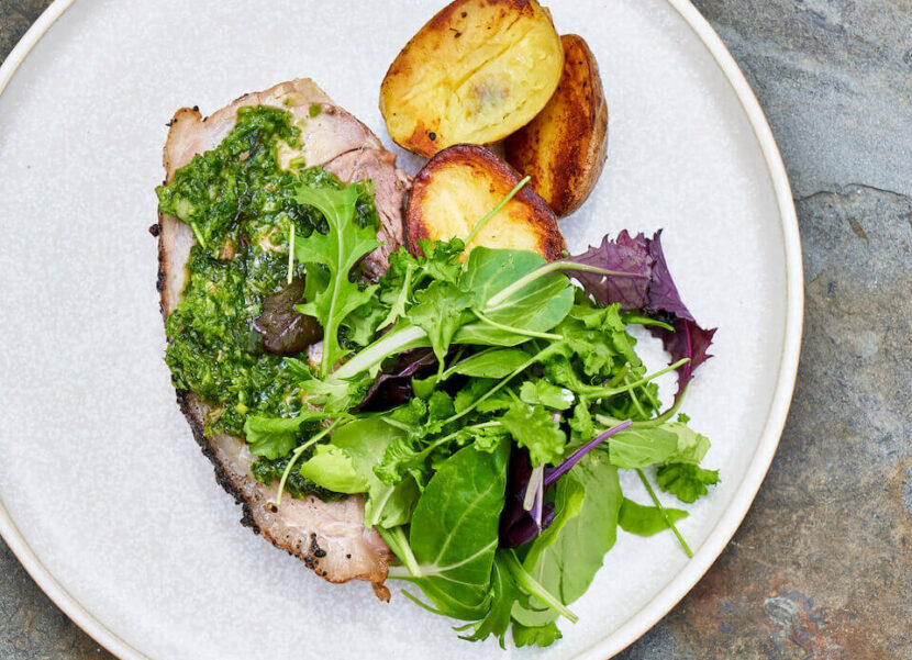 Plated Meal Meat, potatoes, and greens on a plate